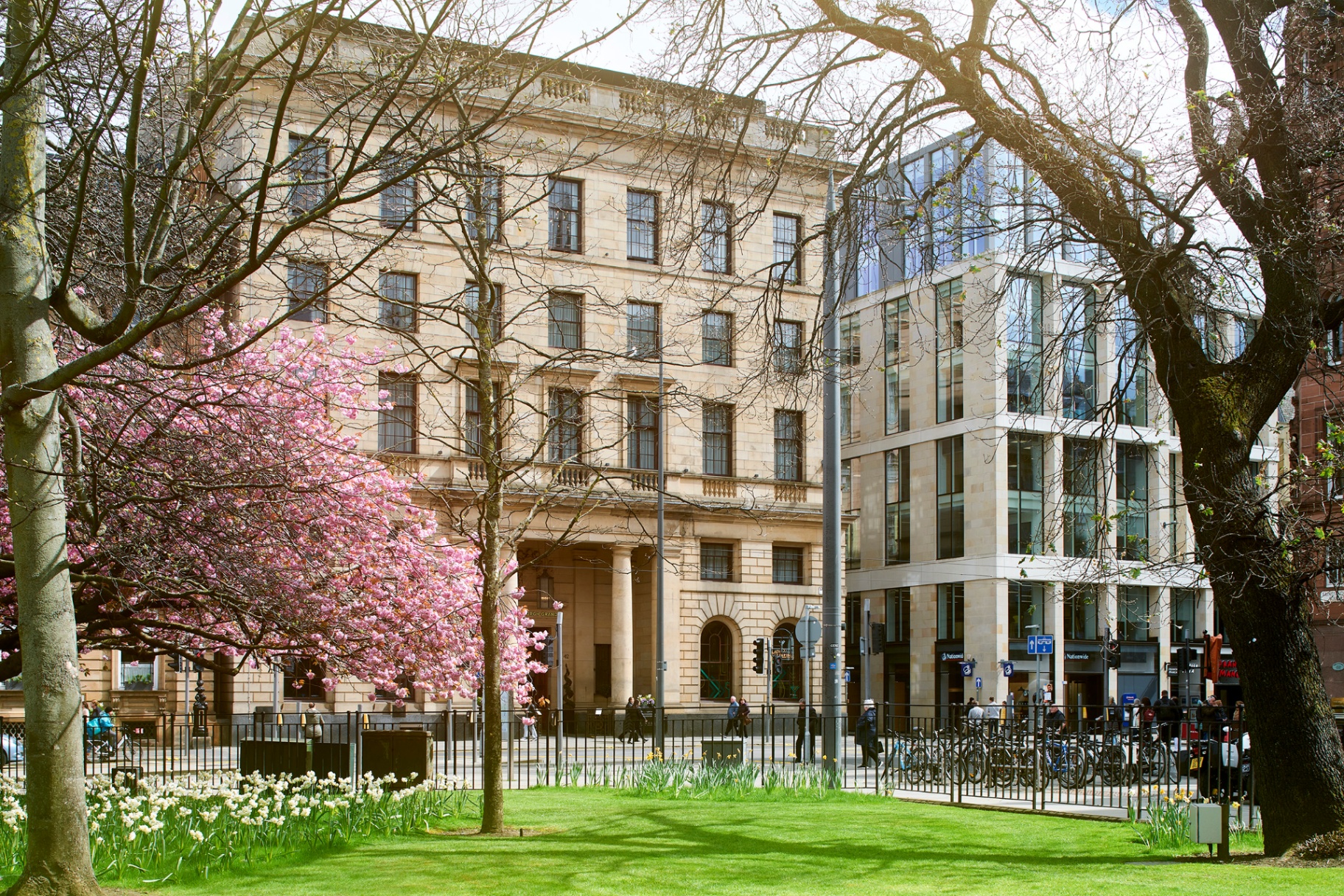 The Edinburgh Grand exterior on St Andrew Square framed by spring cherry blossom